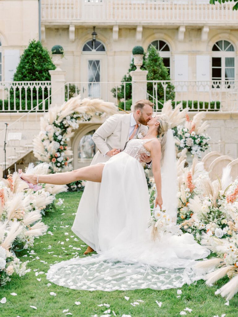 Bride and groom in front of the wedding arch at chateau n3