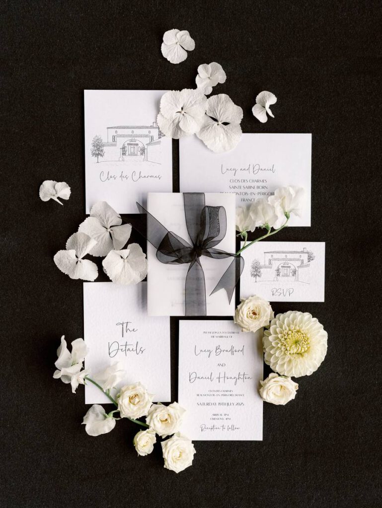 wedding invitation flatlay in white and black colors