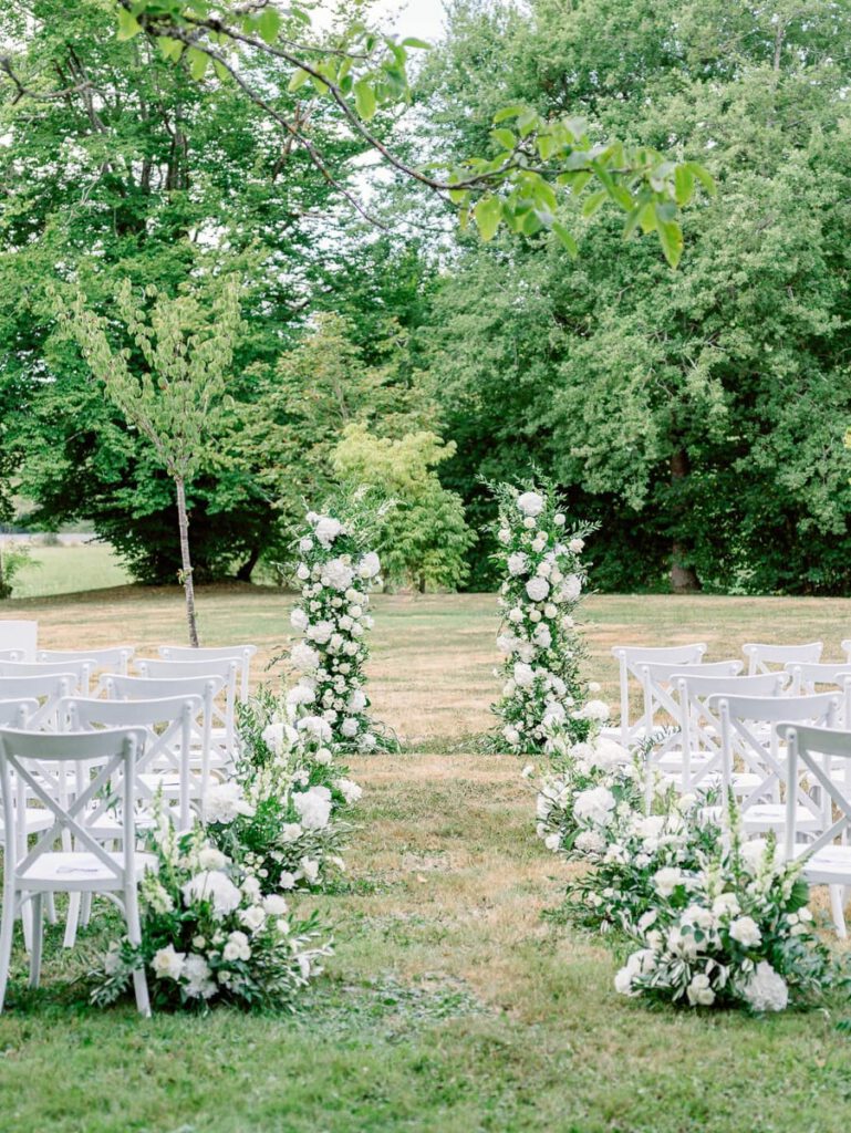 Wedding ceremony arch with white flowers at clos des charmes