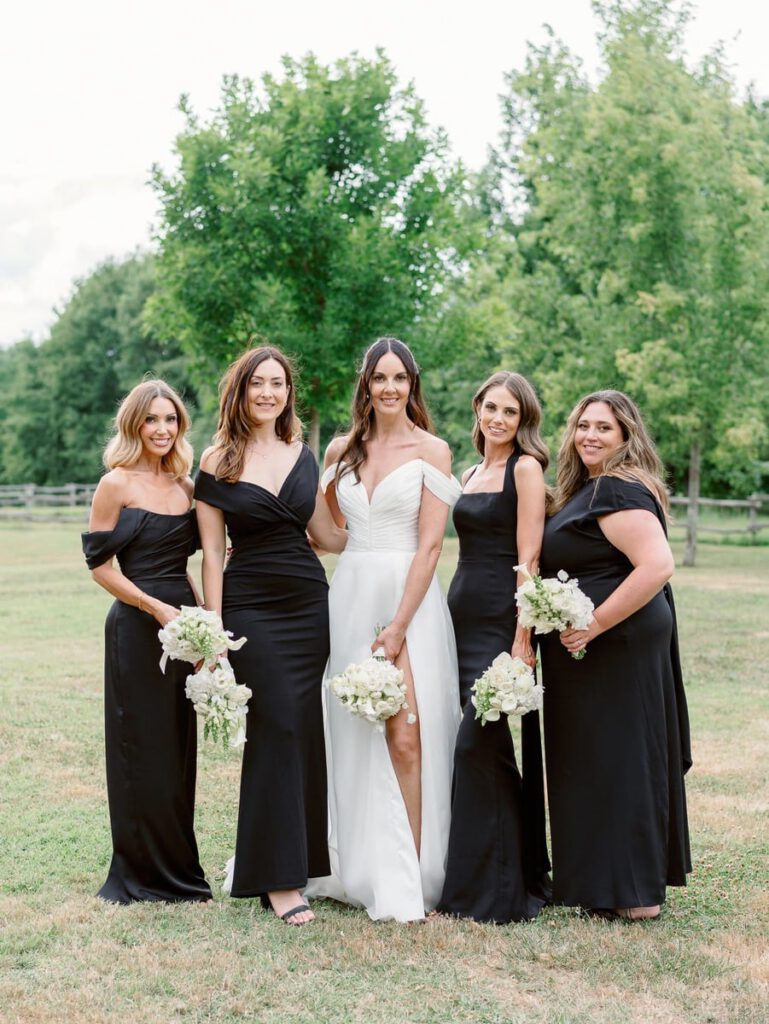 Bride and her bridesmaids in black dresses
