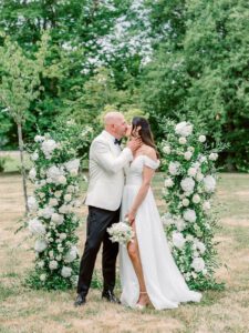 Bride and groom portrait in front of the wedding arch at clos des charmes