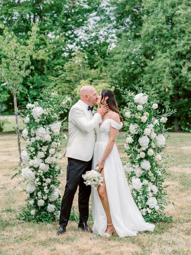 Bride and groom portrait in front of the wedding arch at clos des charmes