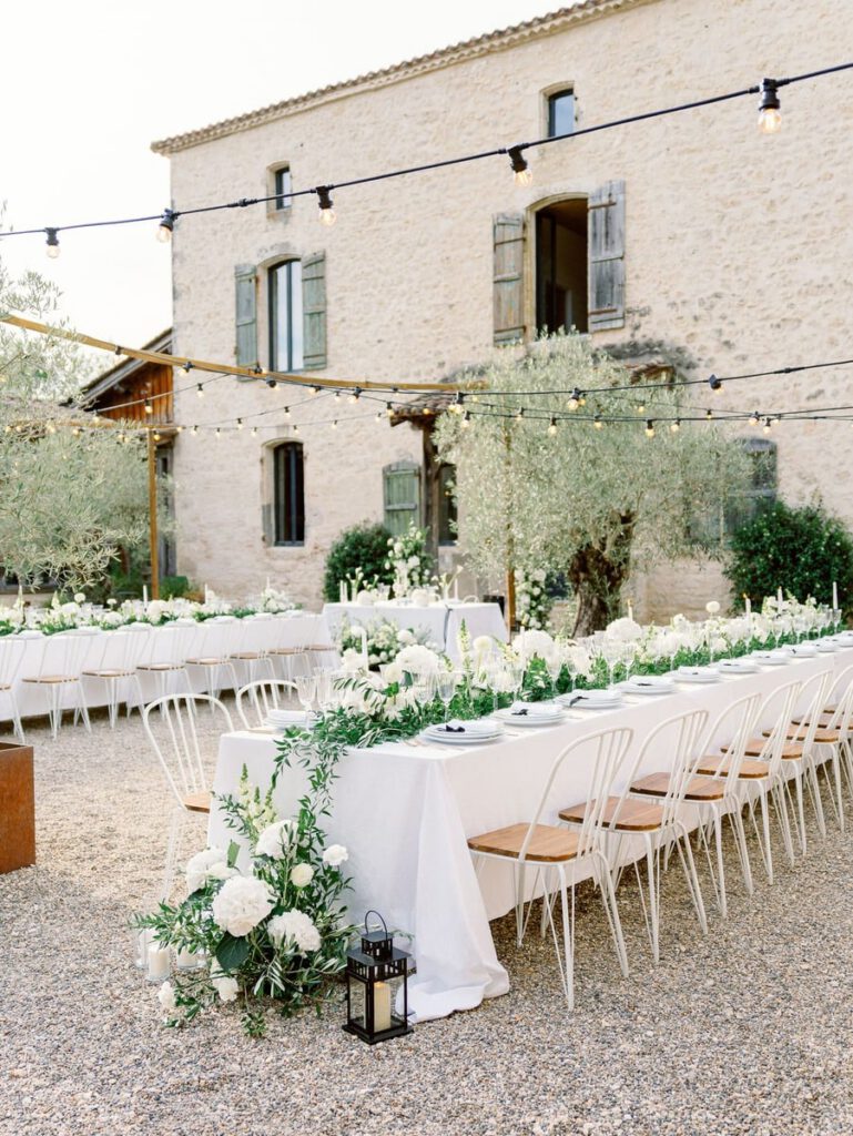 wedding table at clos des charmes with a white tablecloth, white flowers, foliage