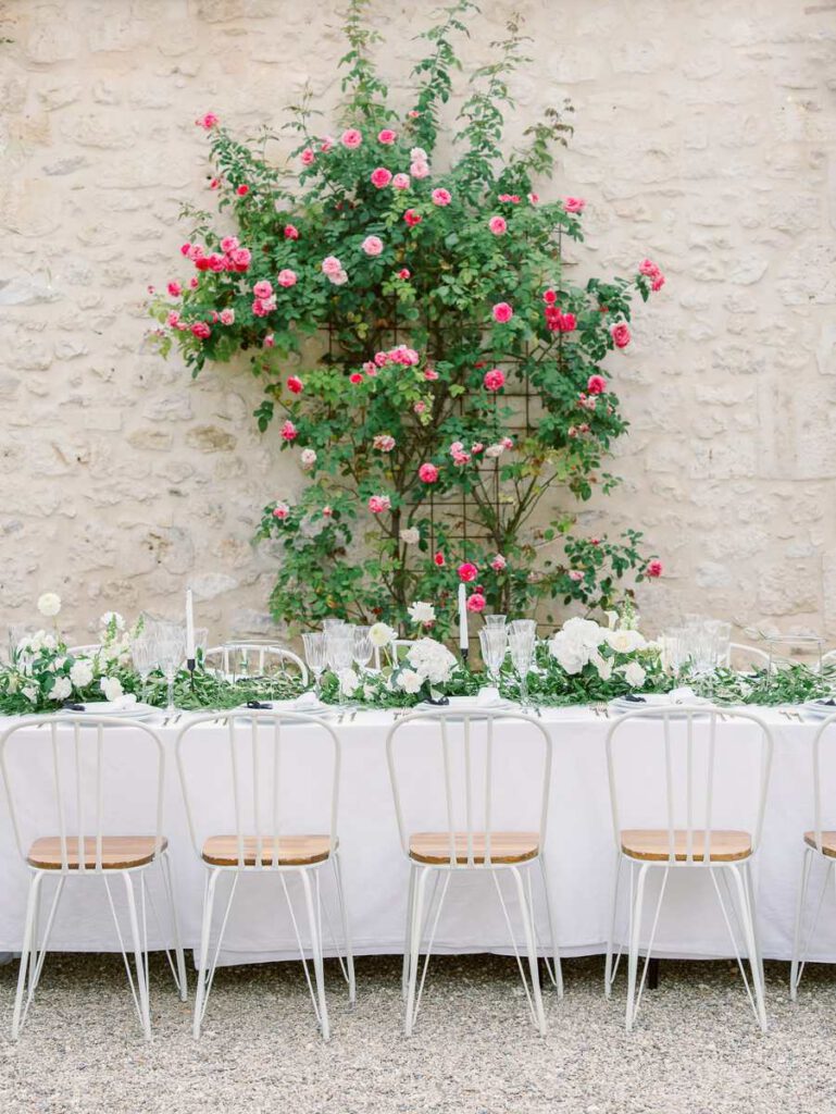 wedding table at clos des charmes with a white tablecloth, white flowers, foliage