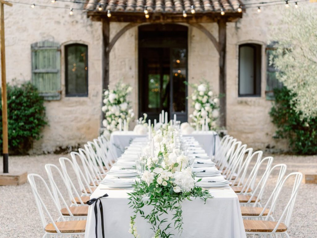 wedding table at clos des charmes with a white tablecloth, white flowers, foliage
