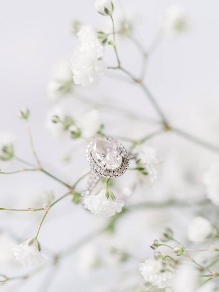 wedding ring on white flowers