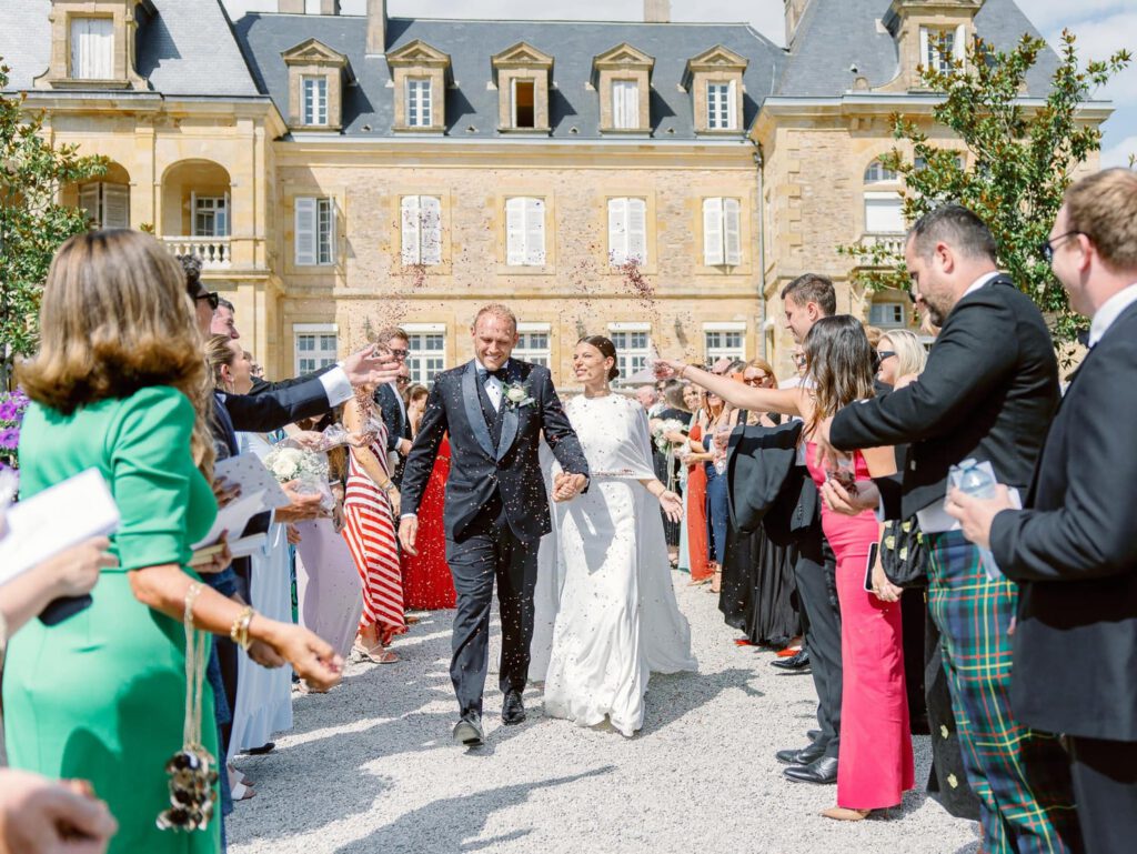 Bride and groom exit during their wedding ceremony at Domaine d'Essendieras