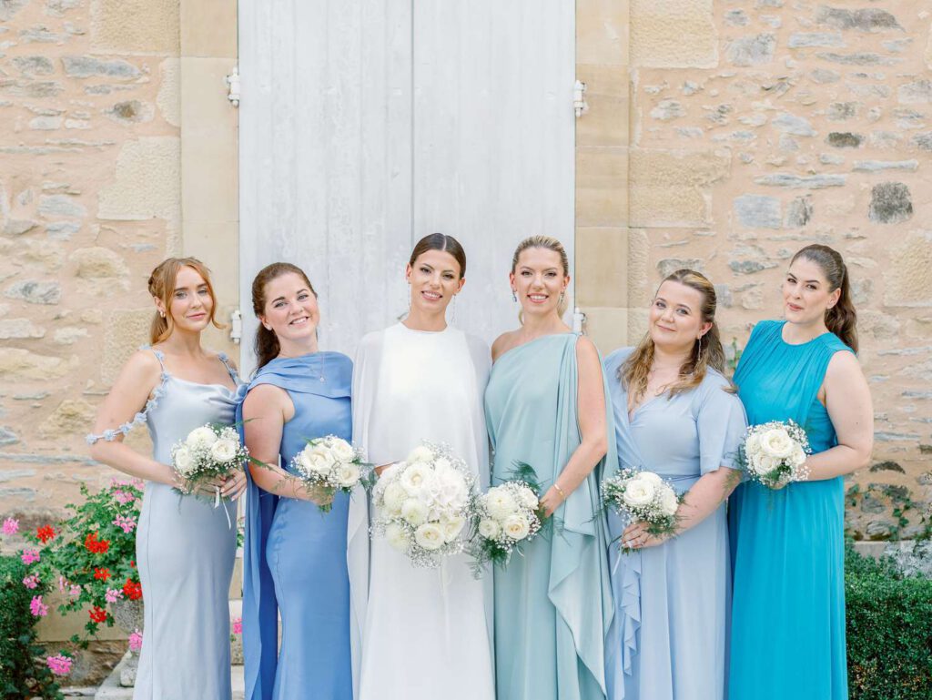 Bride and her bridesmaids with different shades of blue dresses