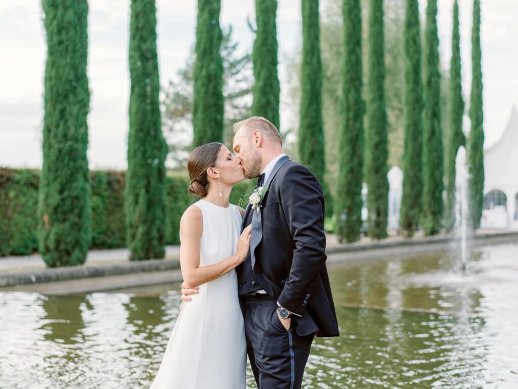 Bride and groom in a cypress alley of Domaine d'Essendieras