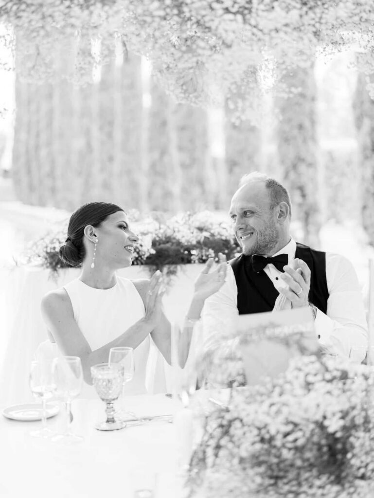 Bride and groom applauding
