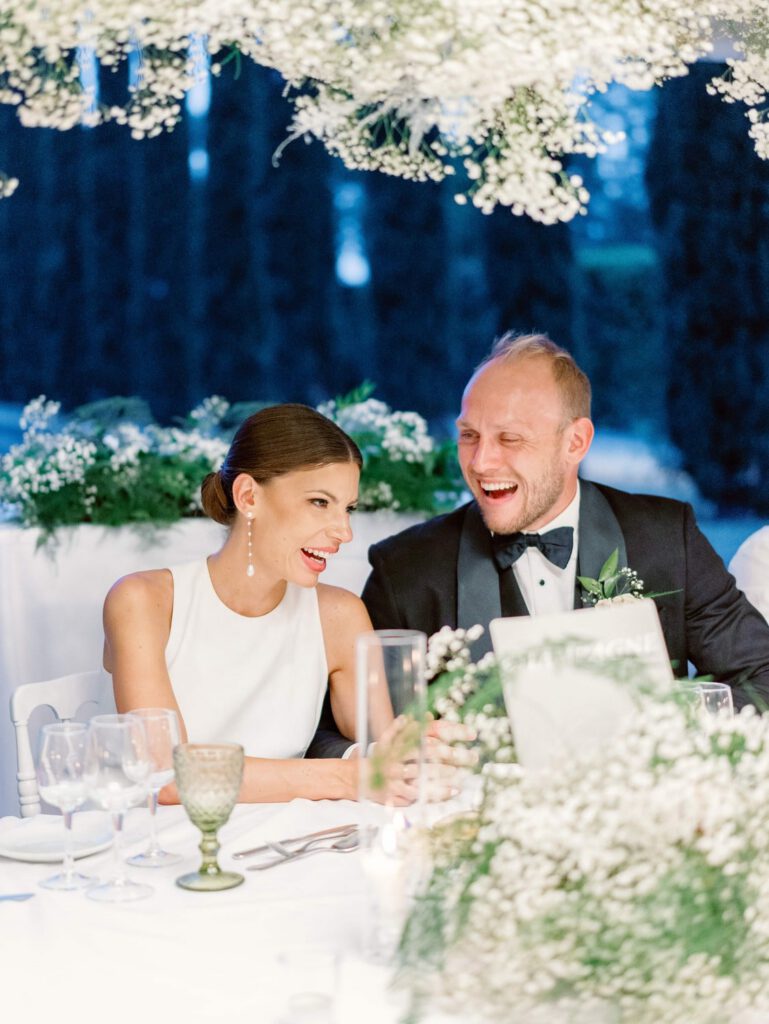 Bride and groom laughing during the dinner