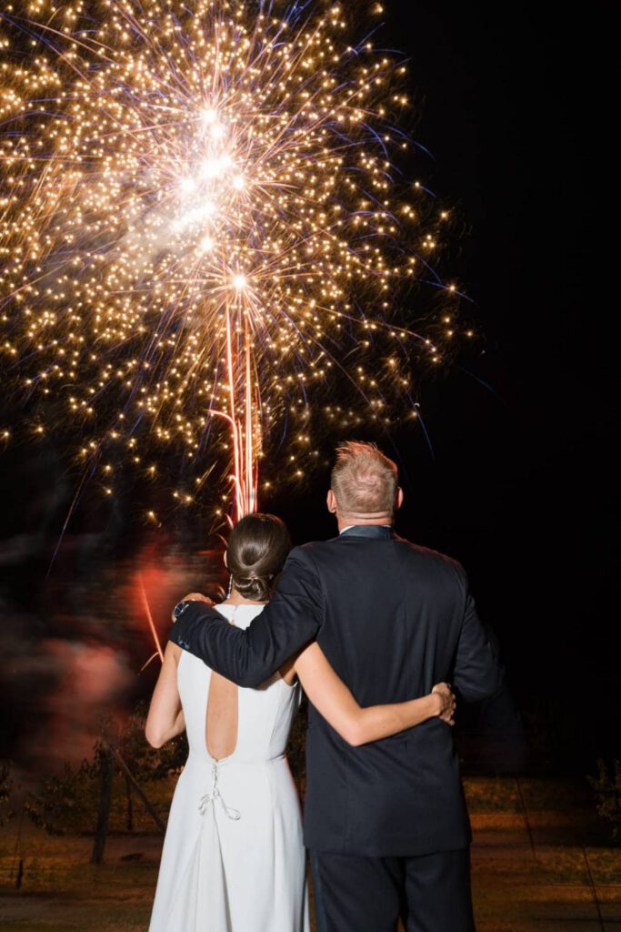 Bride and groom in front of fireworks at at Domaine d'Essendieras