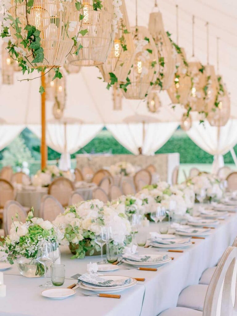 Wedding table with lanterns, green and whites flowers and soft grey linens