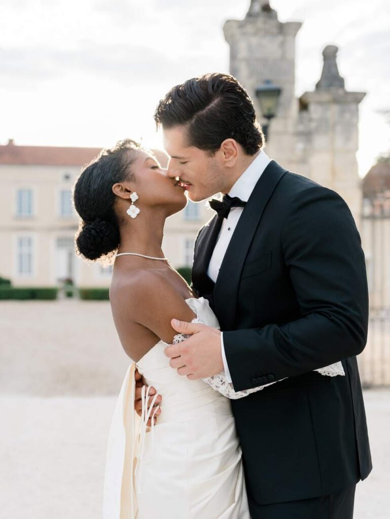 bride and groom kiss at sunset