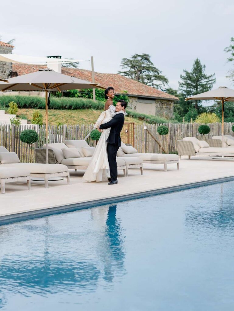 Bride and groom by the pool at Chateau de Bagatelle in Dordogne