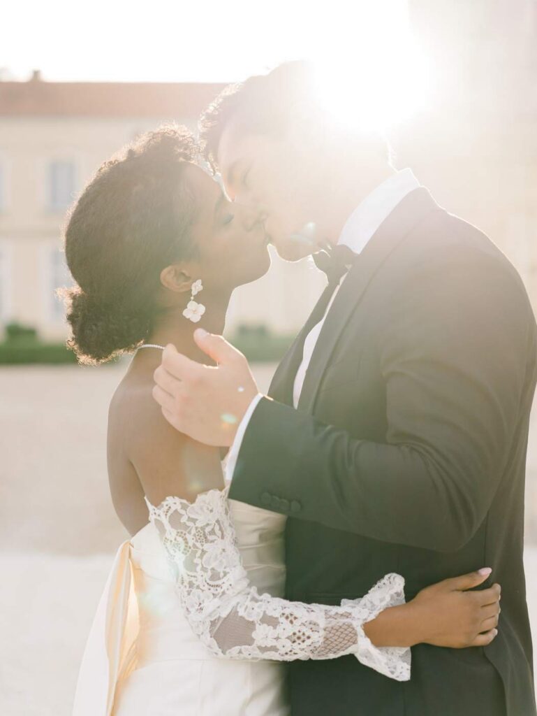 Bride and groom kissing in the sunset