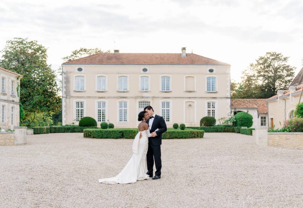 Bride and groom in front of Chateau de Bagatelle in Dordogne