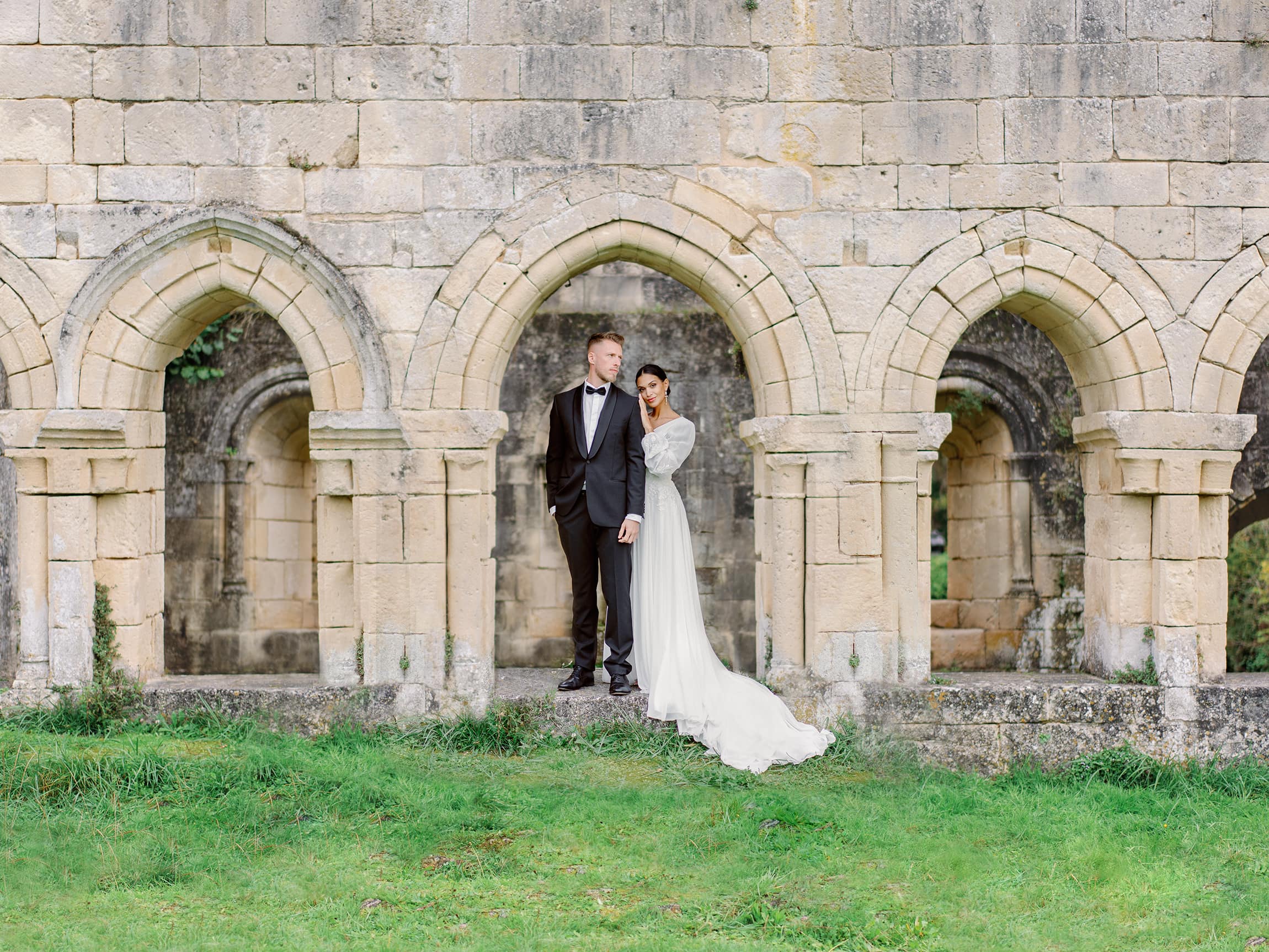 Couple of a Bride and Groom in front of a french abbey
