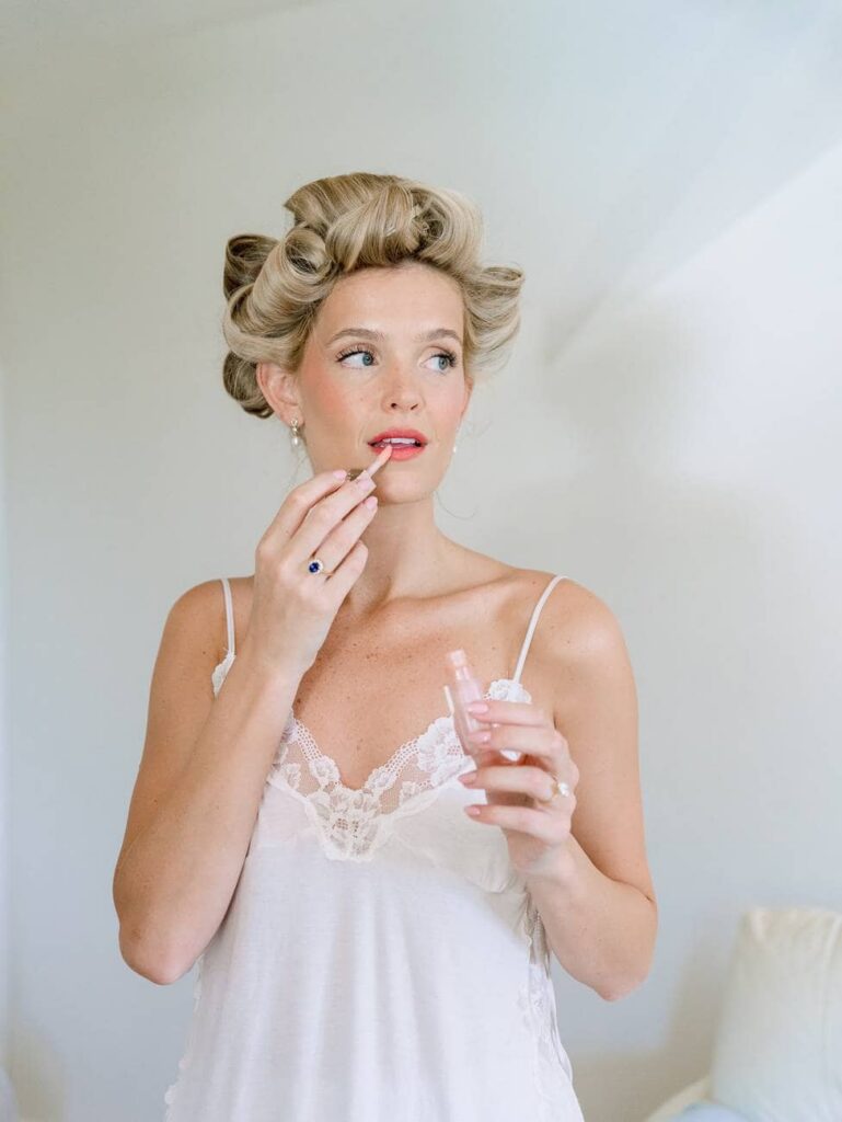 bride putting on lipstick