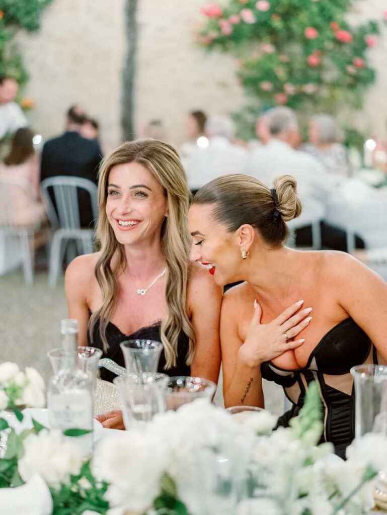 guests laughing during a wedding dinner